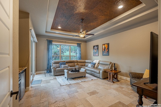 1040 Glenwood, Bulverde, TX 78163 - living area with a tray ceiling, ceiling fan, baseboards, stone tile floors, and recessed lighting