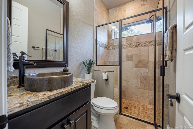 1040 Glenwood, Bulverde, TX 78163 - full bathroom with a shower stall, a textured wall, toilet, vanity, and tile patterned flooring