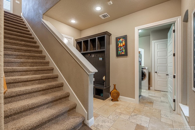 1040 Glenwood, Bulverde, TX 78163 - staircase with stone tile floors, washer / dryer, baseboards, recessed lighting, and a textured ceiling