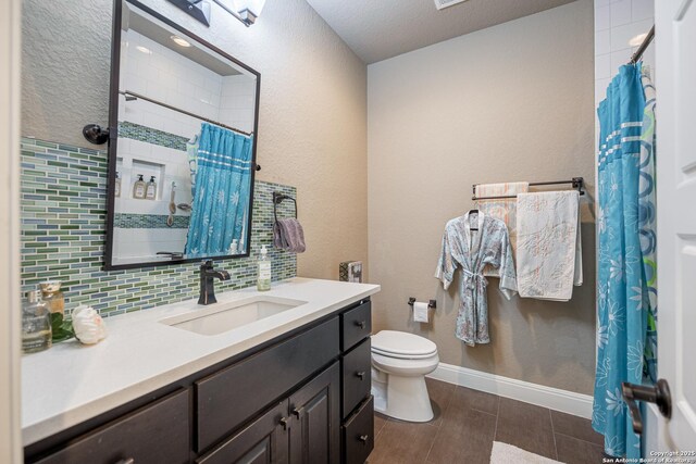 1040 Glenwood, Bulverde, TX 78163 - bathroom featuring toilet, vanity, a shower with shower curtain, tasteful backsplash, and baseboards