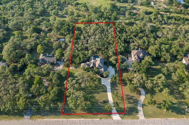 1040 Glenwood, Bulverde, TX 78163 - aerial view of property and surrounding area with property parcel outlined and a heavily wooded area