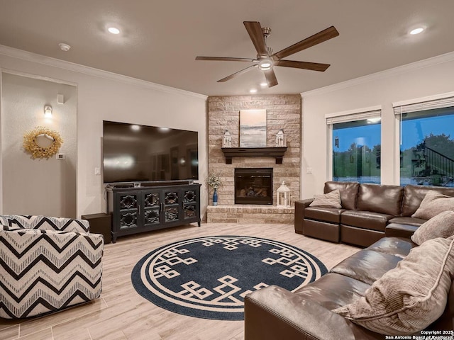 living area with ceiling fan, ornamental molding, wood finished floors, a fireplace, and recessed lighting