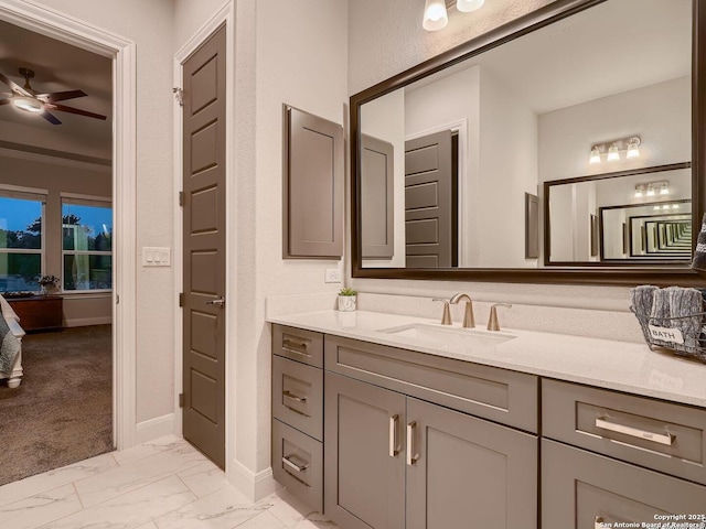 bathroom featuring vanity, baseboards, marble finish flooring, ceiling fan, and connected bathroom