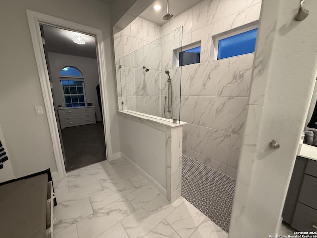 bathroom featuring walk in shower, marble finish floors, and baseboards