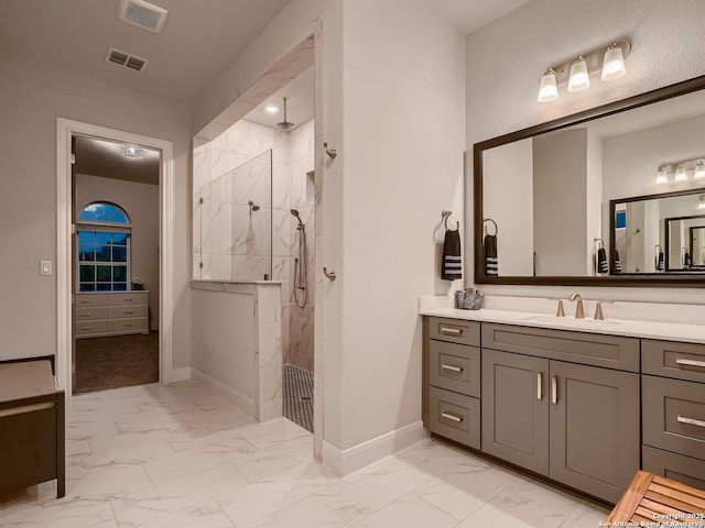 full bathroom with marble look tiles, baseboards, vanity, and walk in shower
