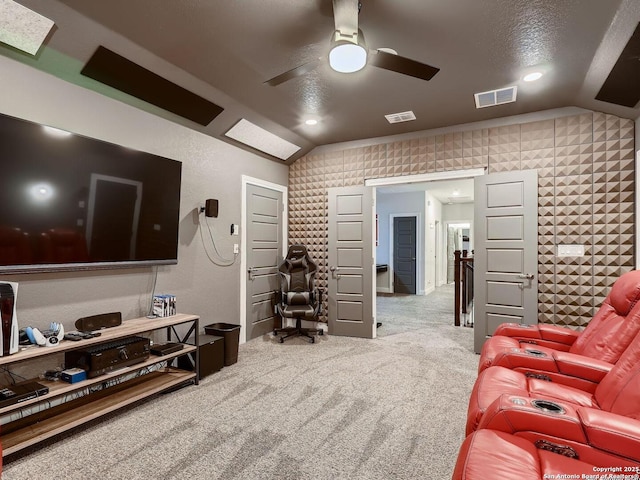 living area with vaulted ceiling, carpet, and a ceiling fan