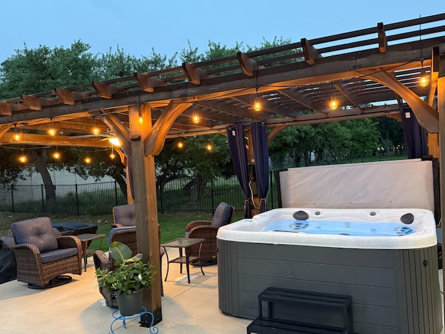 view of patio / terrace featuring a hot tub, fence, and a pergola
