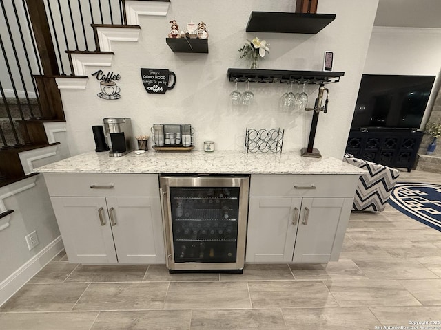 indoor dry bar featuring wine cooler and baseboards