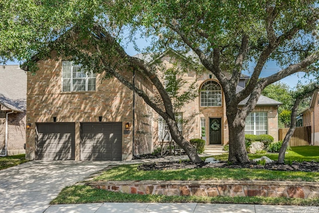 823 Peg Oak, San Antonio, TX 78258 - traditional-style house with an attached garage, brick siding, fence, and concrete driveway