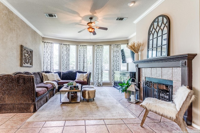 823 Peg Oak, San Antonio, TX 78258 - living room featuring a ceiling fan, a tile fireplace, and ornamental molding
