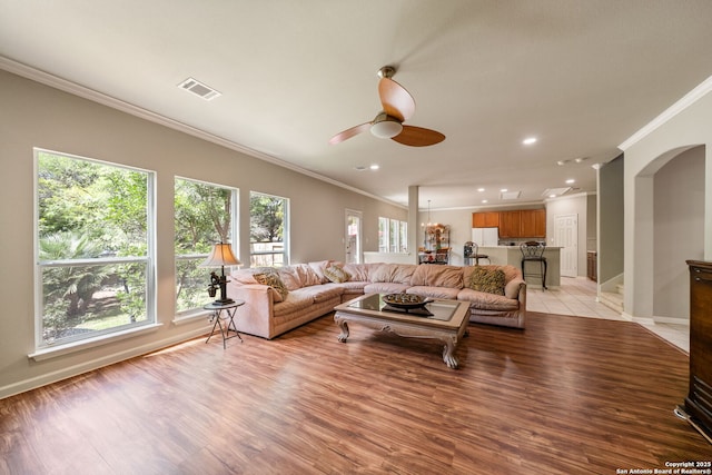 38 Atwell, San Antonio, TX 78254 - living room with crown molding, ceiling fan, light wood-type flooring, arched walkways, and recessed lighting