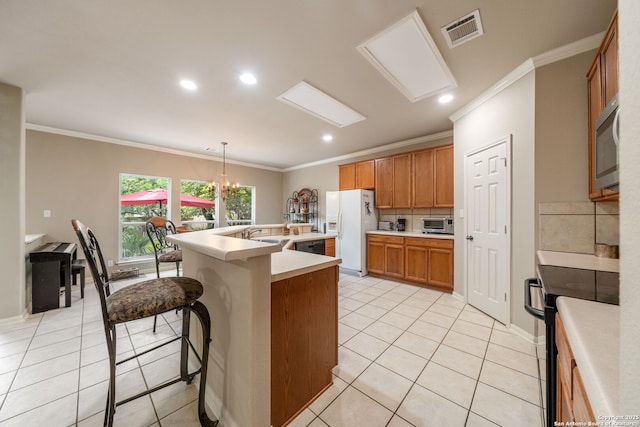 38 Atwell, San Antonio, TX 78254 - kitchen with black appliances, decorative backsplash, crown molding, a kitchen island with sink, and light countertops
