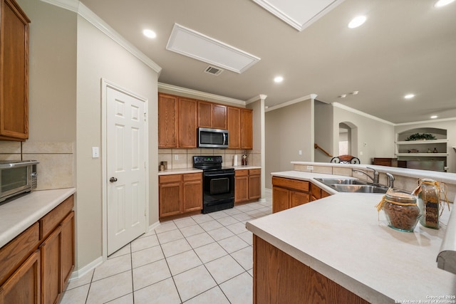 38 Atwell, San Antonio, TX 78254 - kitchen with stainless steel microwave, electric range, crown molding, a sink, and arched walkways