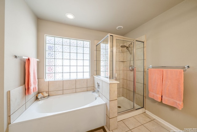 38 Atwell, San Antonio, TX 78254 - bathroom featuring tile patterned floors, a shower stall, a bath, and baseboards