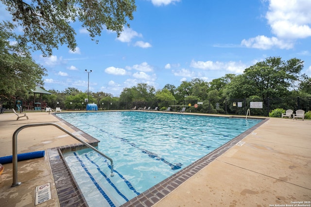 38 Atwell, San Antonio, TX 78254 - community pool with fence, view of wooded area, and a patio