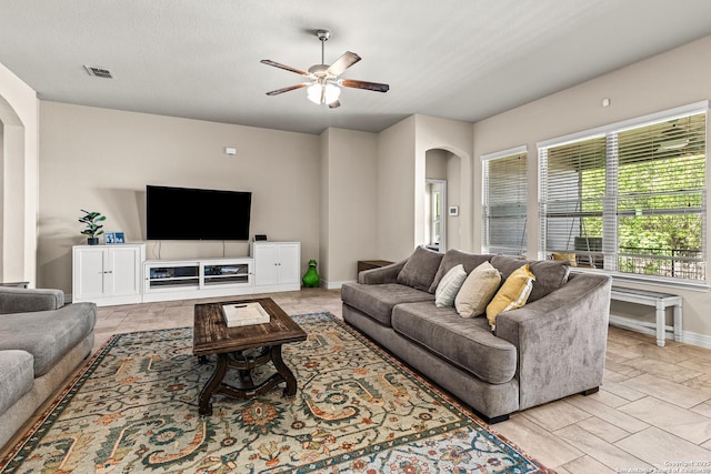 1002 Faith Rnch, San Antonio, TX 78245 - living room featuring arched walkways, a ceiling fan, and baseboards