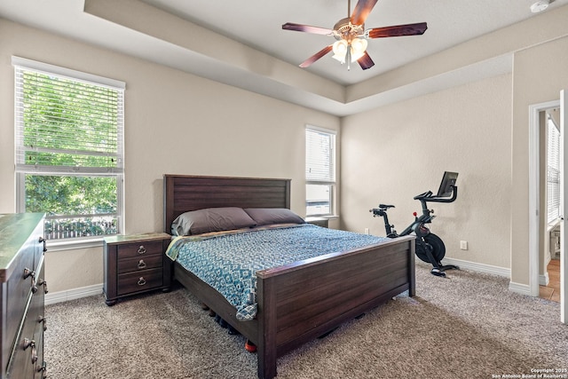 1002 Faith Rnch, San Antonio, TX 78245 - bedroom featuring light colored carpet, baseboards, a raised ceiling, and a ceiling fan