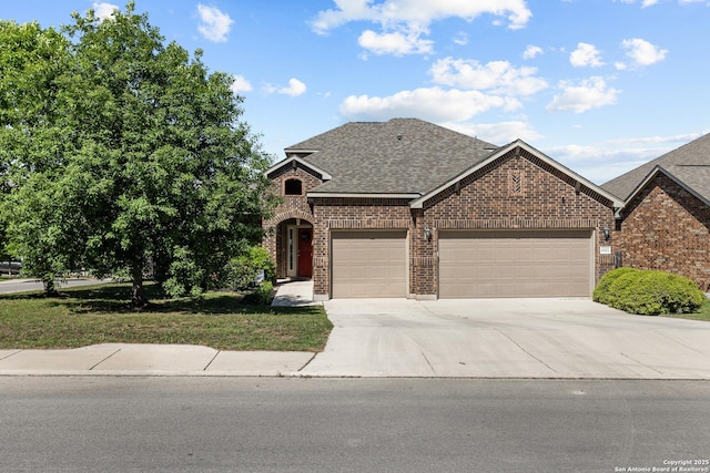 1002 Faith Rnch, San Antonio, TX 78245 - view of front of property with brick siding, driveway, an attached garage, and a shingled roof