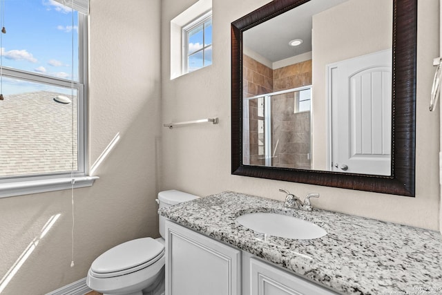 1002 Faith Rnch, San Antonio, TX 78245 - full bath featuring vanity, toilet, a stall shower, and a textured wall