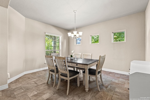 1002 Faith Rnch, San Antonio, TX 78245 - dining room with a chandelier, stone finish flooring, and baseboards
