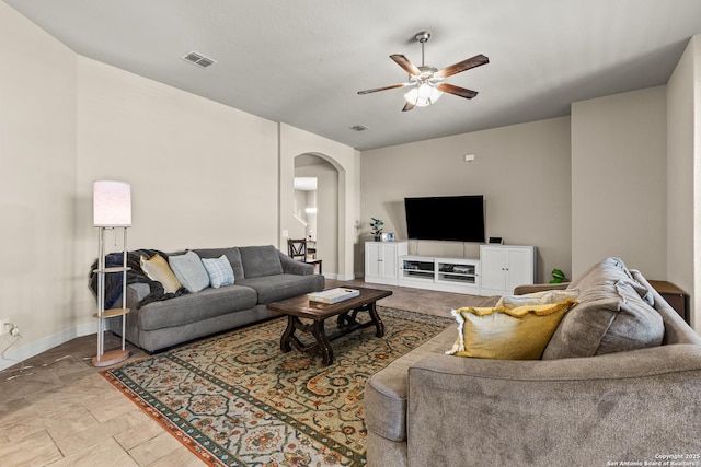 1002 Faith Rnch, San Antonio, TX 78245 - living area featuring arched walkways, ceiling fan, baseboards, and stone finish floors