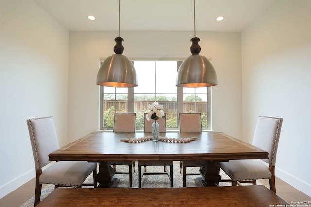 dining space with baseboards, plenty of natural light, recessed lighting, and wood finished floors