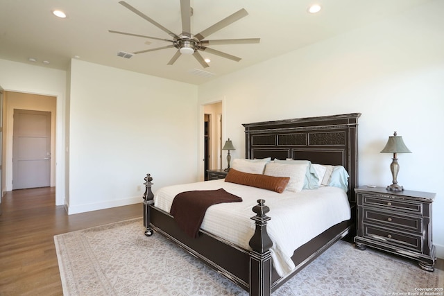 bedroom with wood finished floors, recessed lighting, baseboards, and a ceiling fan