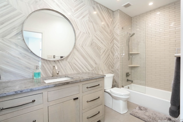 full bath with tile patterned flooring, vanity, toilet, shower / bathtub combination, and decorative backsplash