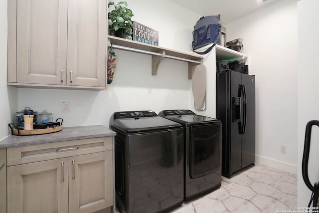 clothes washing area with washer and dryer, cabinet space, baseboards, and light marble finish flooring
