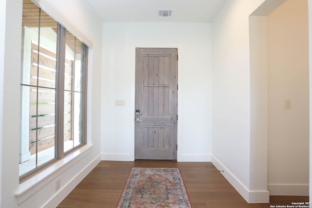 entryway featuring wood finished floors and baseboards