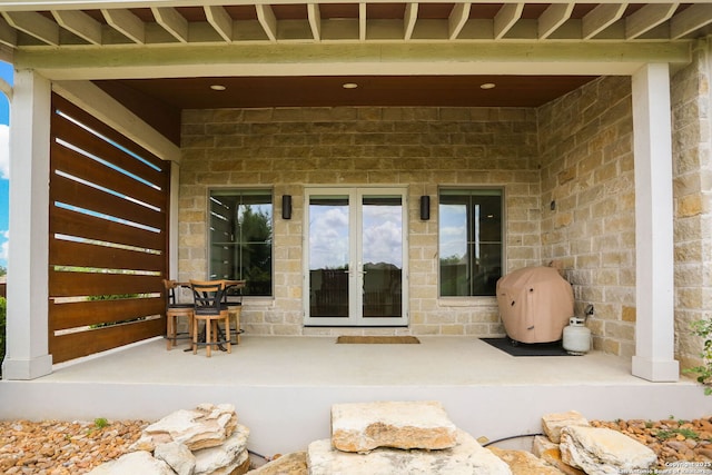 property entrance featuring french doors and a patio area