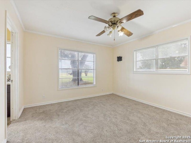 1010 Country Oak Dr, Luling, TX 78648 - carpeted empty room featuring crown molding, ceiling fan, and baseboards