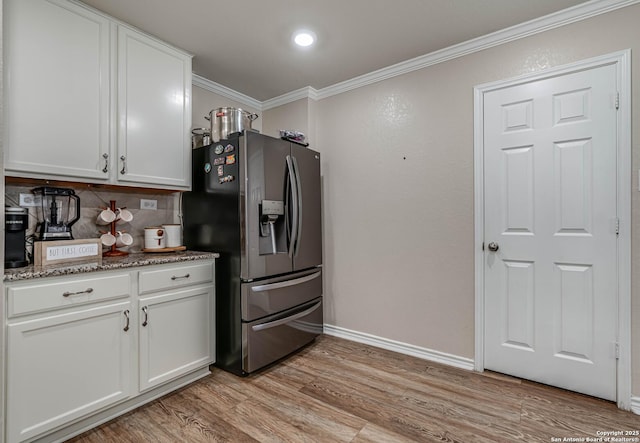 6136 Sunflower, San Antonio, TX 78244 - kitchen featuring stainless steel fridge with ice dispenser, ornamental molding, white cabinets, backsplash, and baseboards