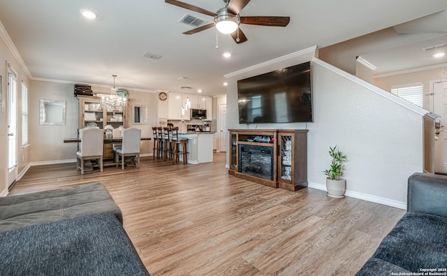 6136 Sunflower, San Antonio, TX 78244 - living area with a ceiling fan, crown molding, light wood-style floors, baseboards, and recessed lighting