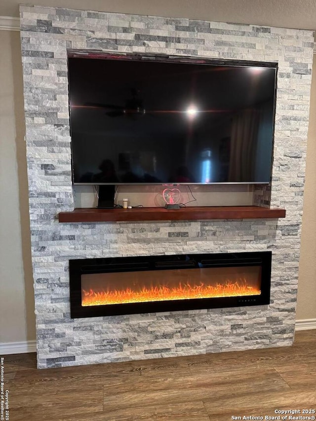 6136 Sunflower, San Antonio, TX 78244 - detailed view of a fireplace, baseboards, wood finished floors, and ornamental molding