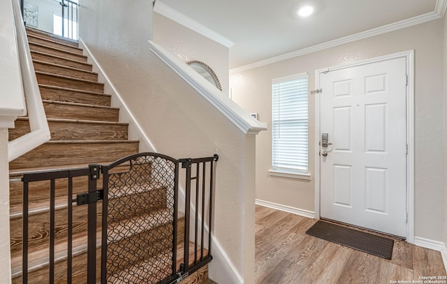 6136 Sunflower, San Antonio, TX 78244 - entryway featuring wood finished floors, crown molding, baseboards, and stairway