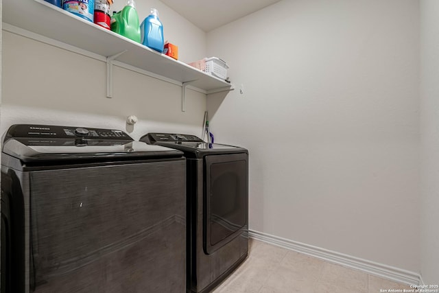 6136 Sunflower, San Antonio, TX 78244 - laundry room featuring washing machine and clothes dryer, baseboards, and light tile patterned floors