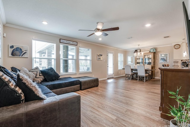6136 Sunflower, San Antonio, TX 78244 - living room with a chandelier, a ceiling fan, light wood-style flooring, baseboards, and ornamental molding
