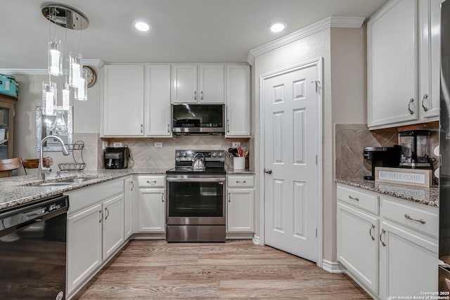 6136 Sunflower, San Antonio, TX 78244 - kitchen featuring stainless steel appliances, a sink, white cabinets, decorative backsplash, and recessed lighting