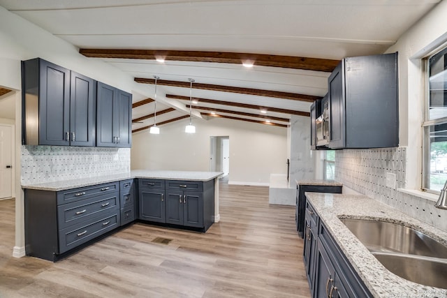 13635 Owl Tree, San Antonio, TX 78253 - kitchen with a sink, a peninsula, tasteful backsplash, light wood-style flooring, and decorative light fixtures