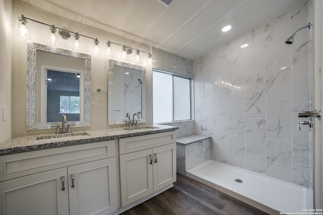 13635 Owl Tree, San Antonio, TX 78253 - full bathroom with tiled shower, wood finished floors, and double vanity