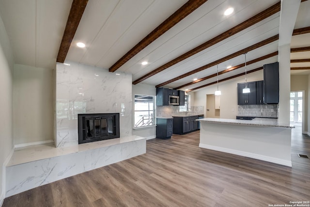 13635 Owl Tree, San Antonio, TX 78253 - unfurnished living room featuring a premium fireplace, a sink, healthy amount of natural light, recessed lighting, and wood finished floors