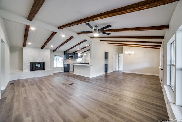 13635 Owl Tree, San Antonio, TX 78253 - unfurnished living room with a chandelier, ceiling fan, a high end fireplace, wood finished floors, and recessed lighting