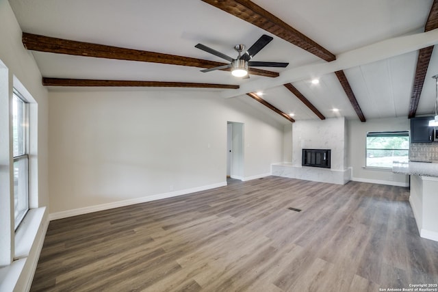 13635 Owl Tree, San Antonio, TX 78253 - unfurnished living room with ceiling fan, wood finished floors, a fireplace, beamed ceiling, and baseboards