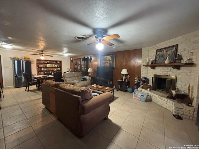 3802 Quiver, San Antonio, TX 78238 - tiled living area with a ceiling fan, a textured ceiling, and a fireplace