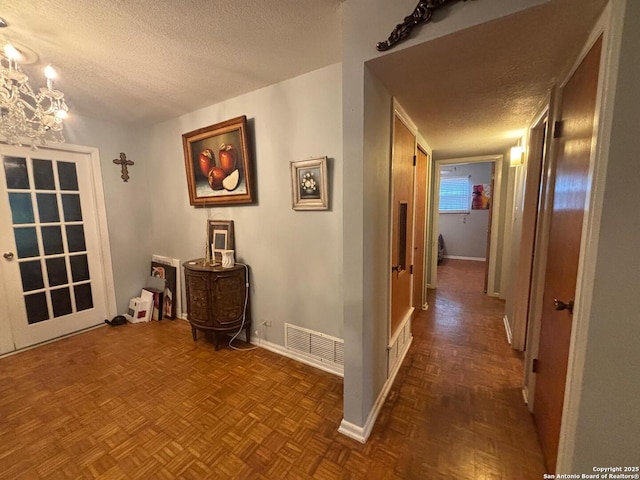 3802 Quiver, San Antonio, TX 78238 - hallway with a textured ceiling, baseboards, and a chandelier
