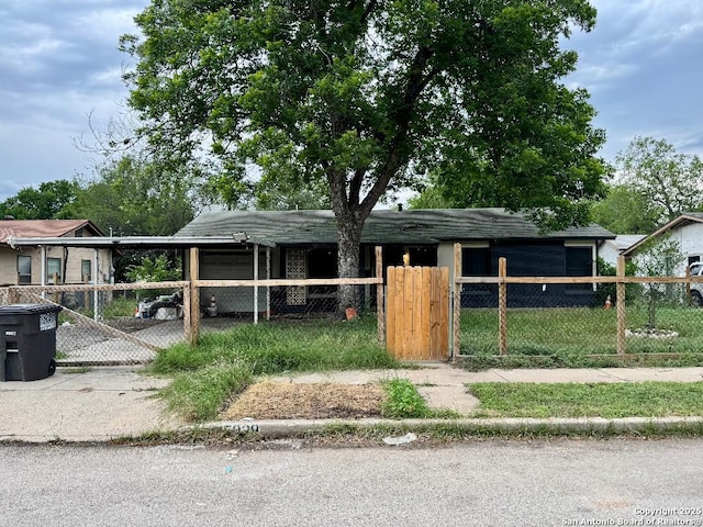 5039 Bayhead, San Antonio, TX 78220 - view of front of house with driveway, a gate, a fenced front yard, and a carport
