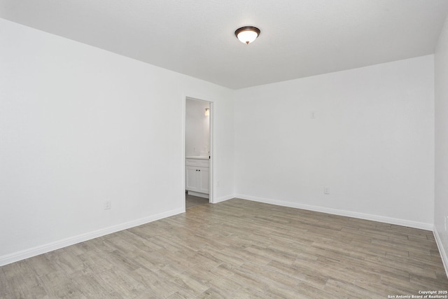 8160E 6th St, Somerset, TX 78069 - empty room featuring light wood-type flooring and baseboards
