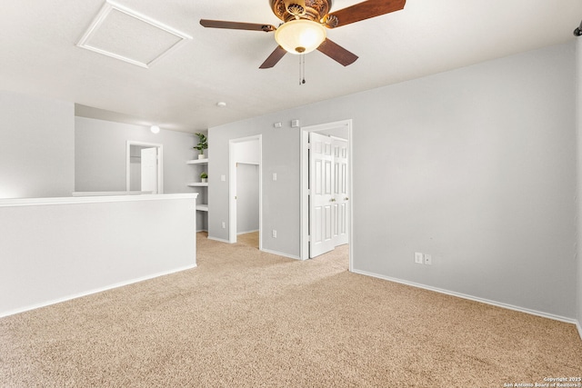 846 Barrel Pt, San Antonio, TX 78251 - spare room featuring light colored carpet, attic access, baseboards, ceiling fan, and built in shelves