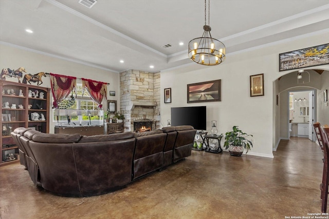 3205 Puter Crk, Spring Branch, TX 78070 - living area with finished concrete flooring, a fireplace, crown molding, a chandelier, and arched walkways